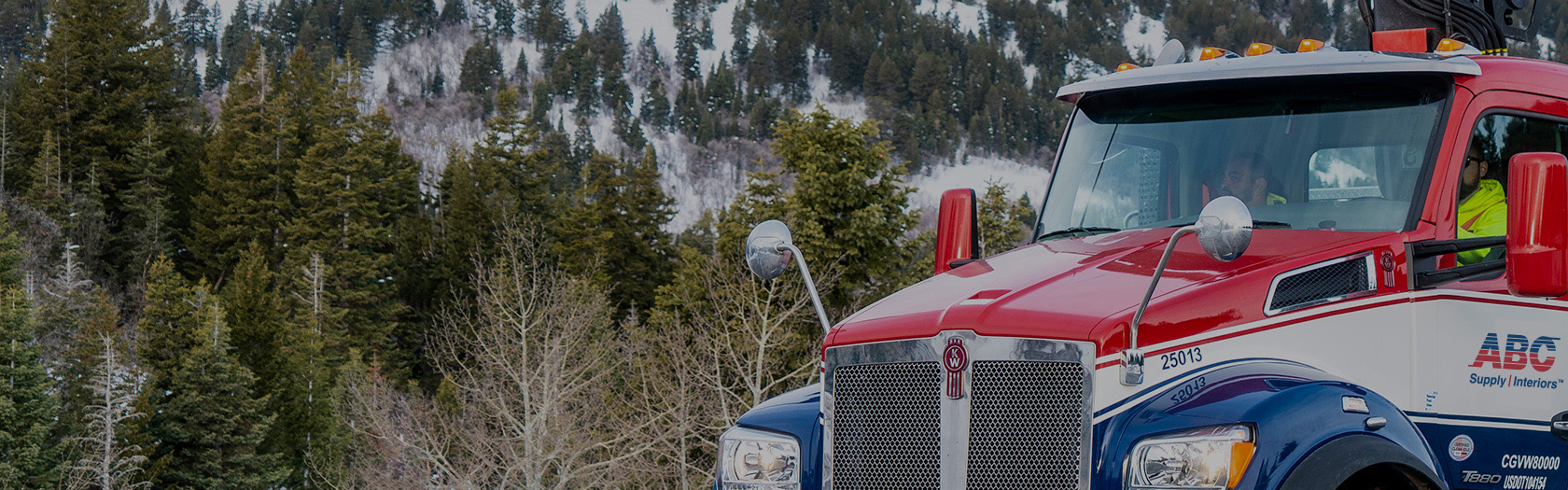 ABC Supply Interiors truck parked infront of mountain in background.