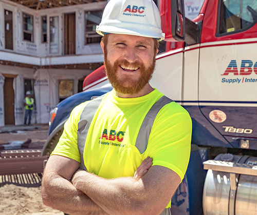 Delivery driver standing with arms crossed, smiling