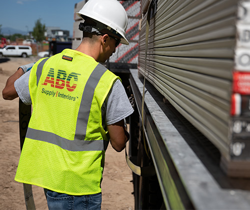 Helper/stocker employee closing truck gate